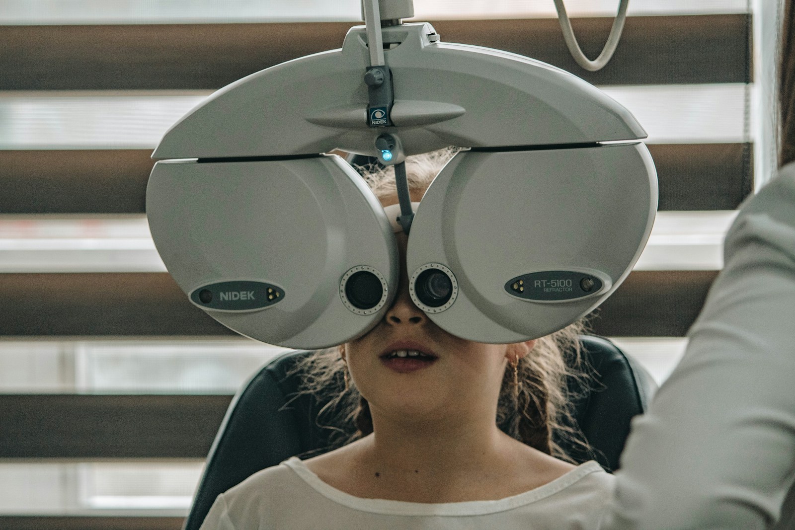 Patient undergoing a vision exam with a phoropter